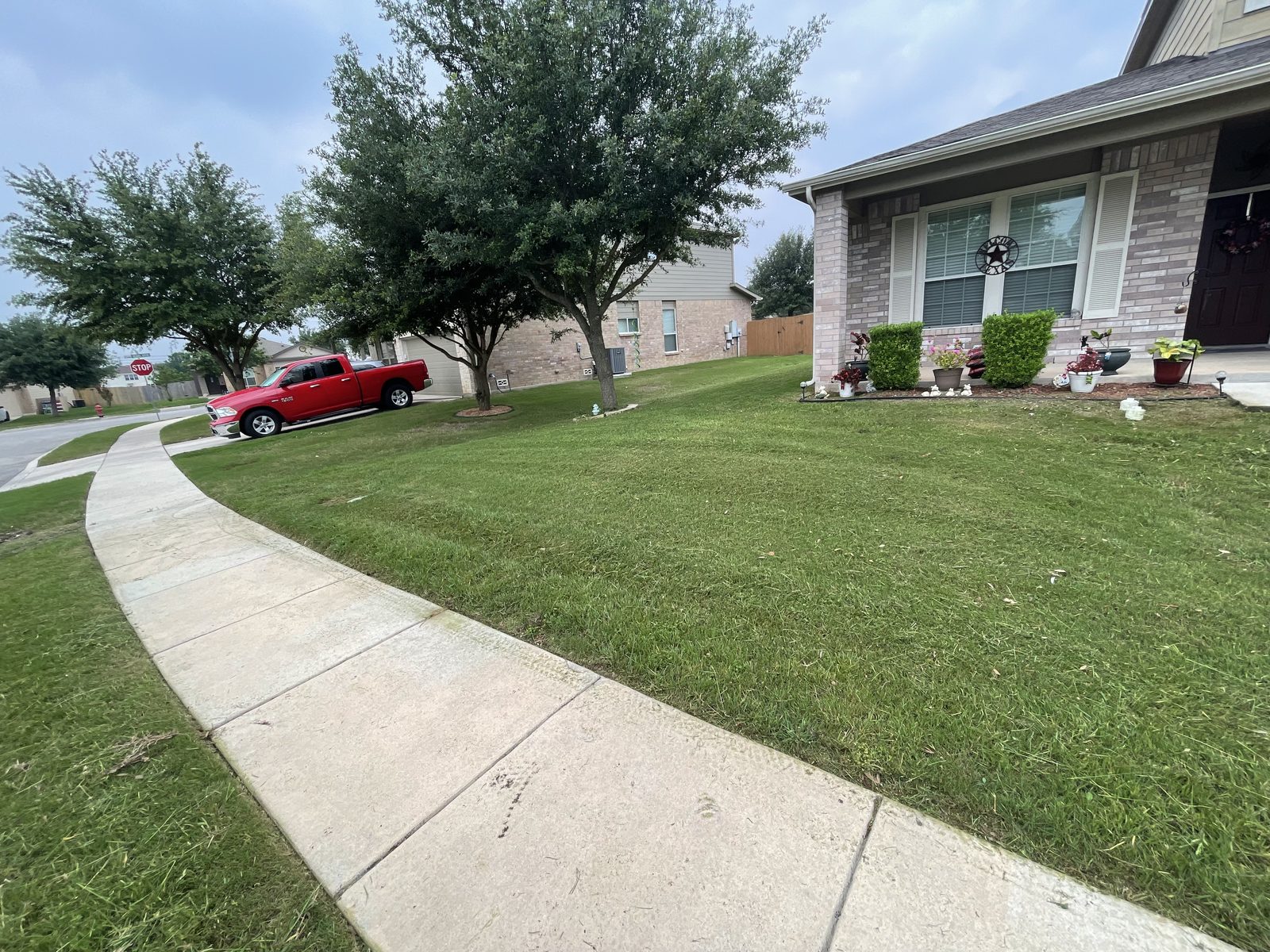 Gonzales Landscaping truck in front of a freshly mowed lawn in Cibolo, TX