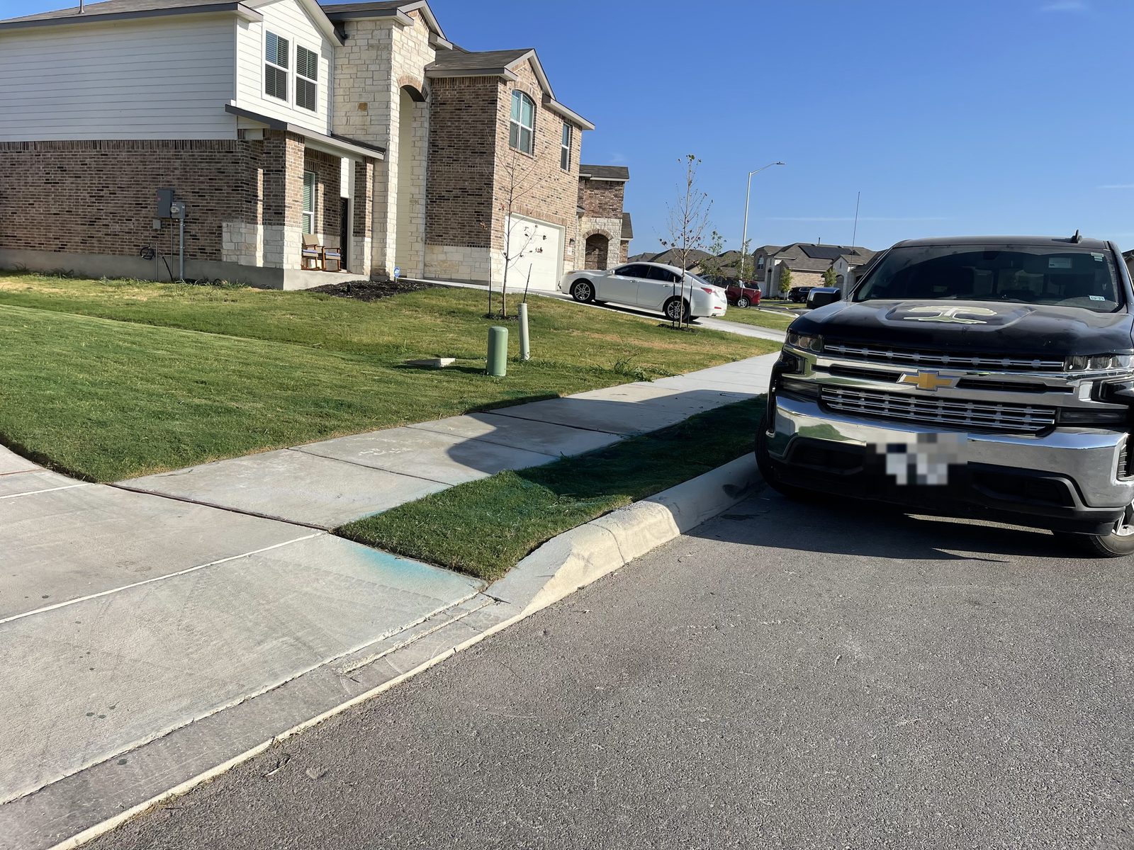 Gonzales Landscaping treatment truck parked curbside during a weed control and lawn health service visit in Cibolo, TX